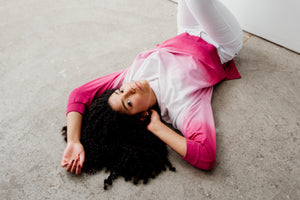 A woman in a pink top lying down